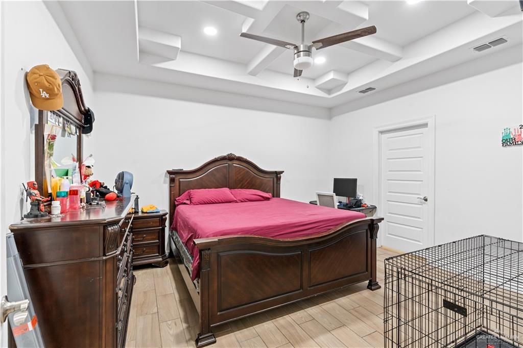 311 Seguin Loop Rio Grande City, TX 78582 - Photo 9 of 15 Recessed lighting illuminating a coffered ceiling with a ceiling fan