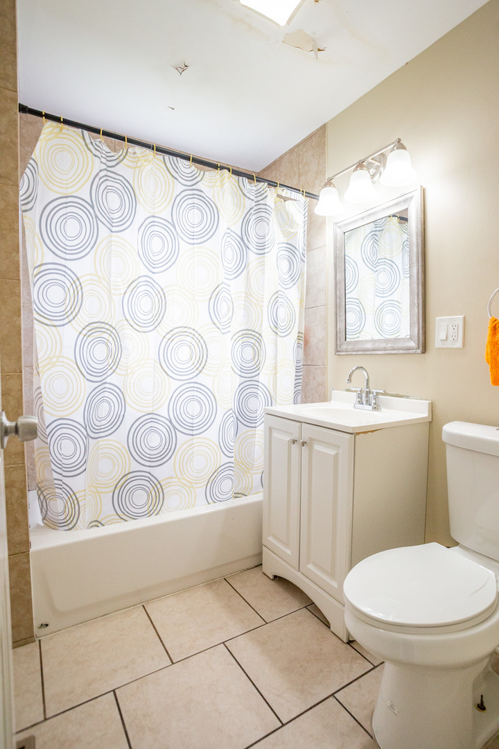 9226 South Ellis Avenue Chicago, IL 60619 - Photo 9 of 17 a bathroom with a toilet sink and mirror