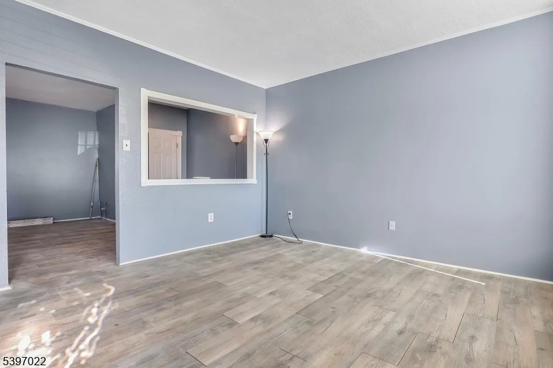 929 Bordentown Road Burlington, NJ 08016 - Photo 2 of 12 a view of an empty room with wooden floor and a window