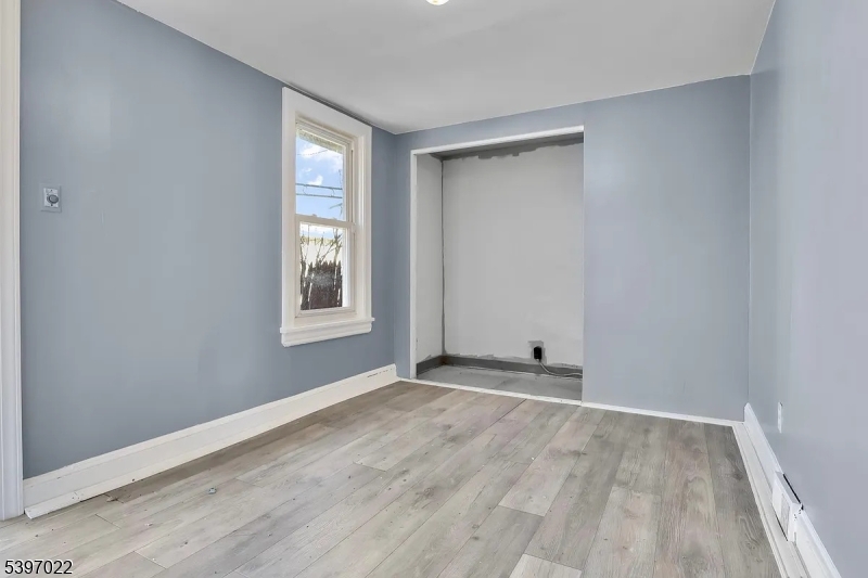 929 Bordentown Road Burlington, NJ 08016 - Photo 9 of 12 a view of an empty room with wooden floor and a window