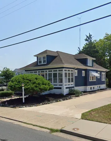 a front view of a house with a garden and plants