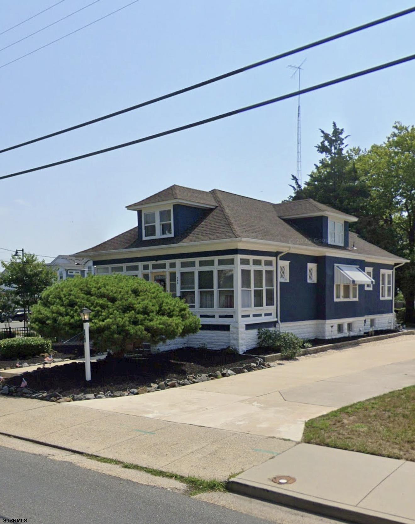 548 Shore Road Somers Point, NJ 08244 - Photo 1 of 2 a front view of a house with a garden and plants