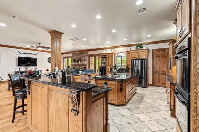 a living room with lots of furniture and kitchen view