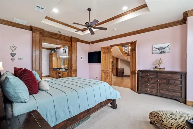 a spacious bedroom with a bed and a chandelier