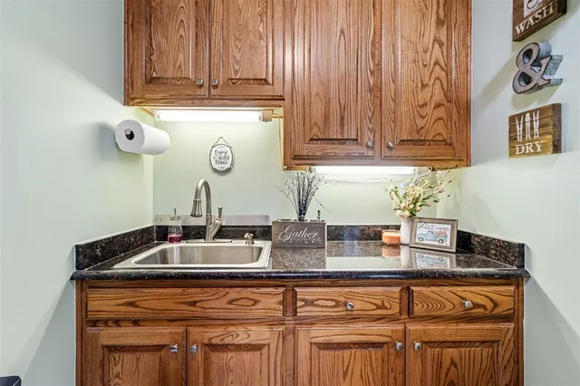 a utility room with sink dryer and washer