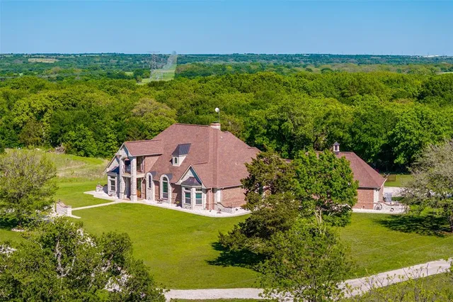 an aerial view of a house with a garden