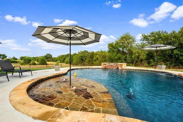 a view of a swimming pool with a patio
