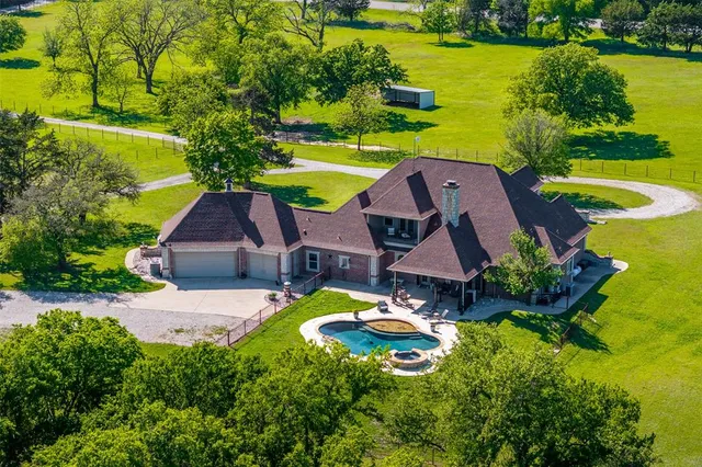 a swimming pool with outdoor seating and yard