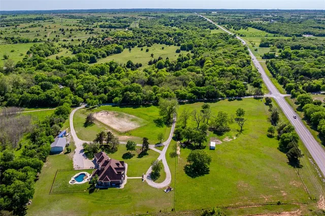 an aerial view of a house with a yard