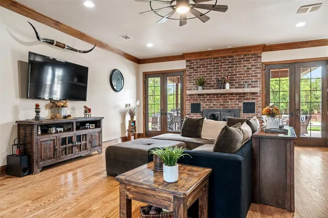 a living room with fireplace furniture and a flat screen tv