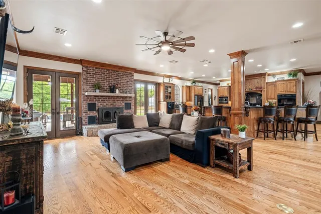 a living room with fireplace furniture and a wooden floor