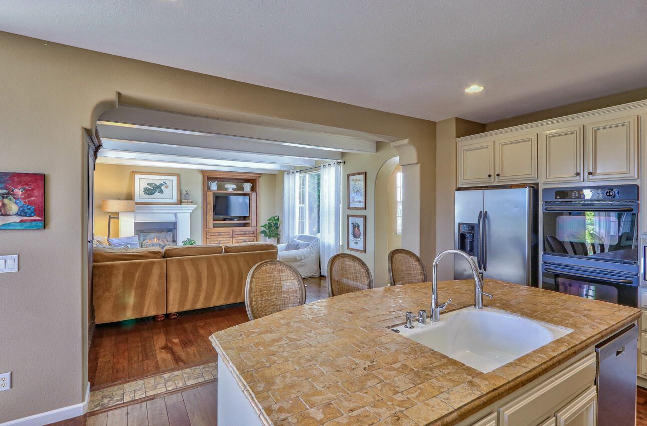 7260 Eagle Ridge Drive Gilroy, CA 95020 - Photo 12 of 36 a kitchen with stainless steel appliances granite countertop a stove top oven a sink dishwasher and cabinets with wooden floor