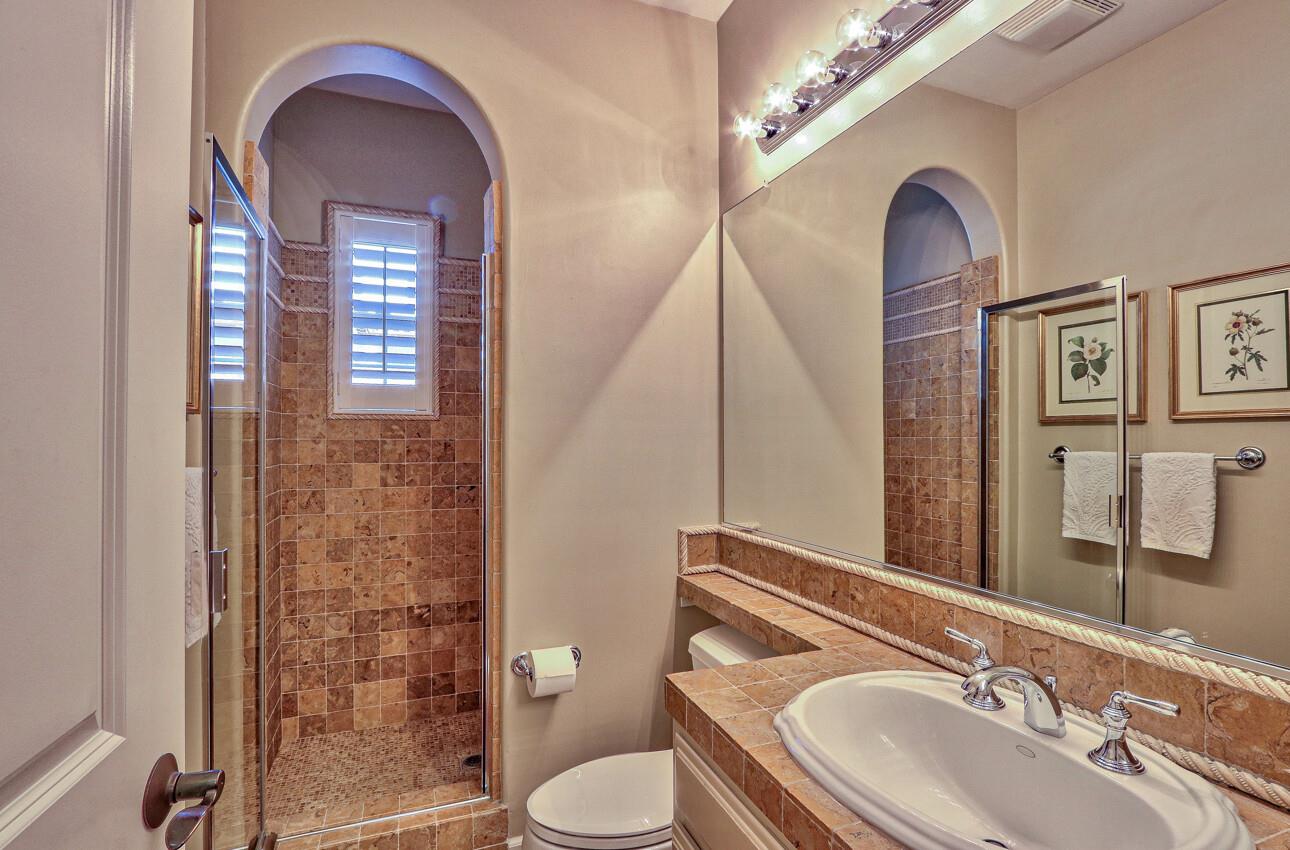 7260 Eagle Ridge Drive Gilroy, CA 95020 - Photo 18 of 36 a bathroom with a granite countertop toilet a sink and a mirror