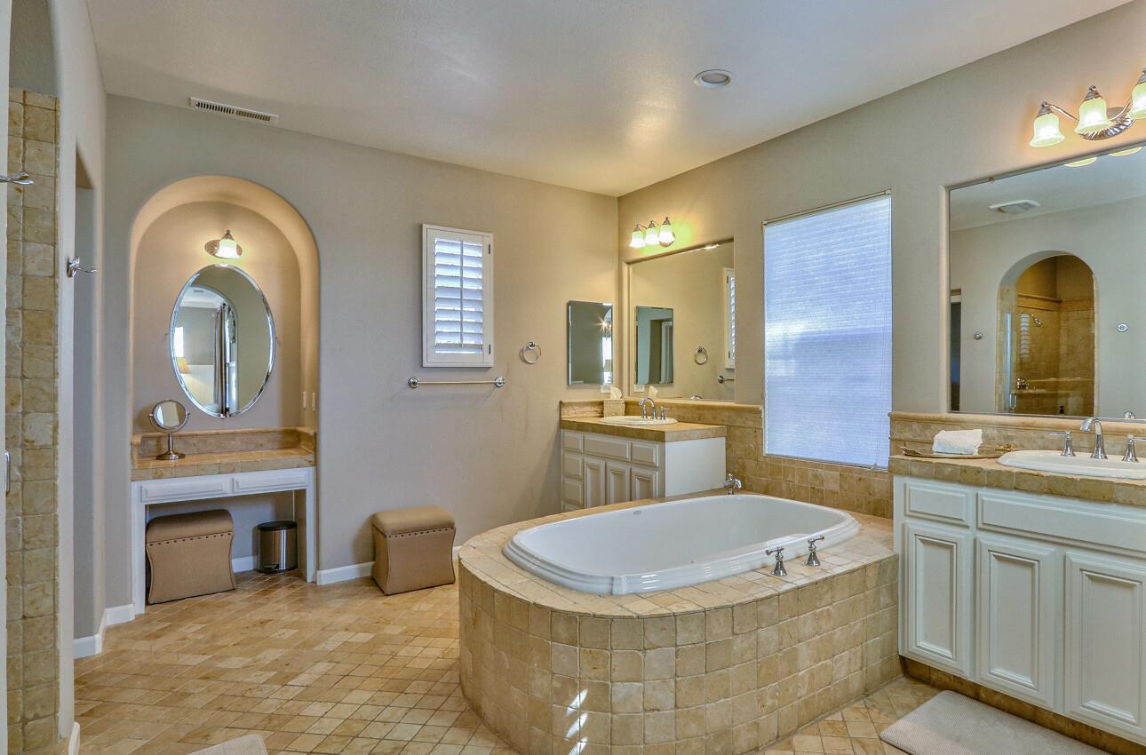 7260 Eagle Ridge Drive Gilroy, CA 95020 - Photo 23 of 36 a bathroom with a tub a sink and a mirror