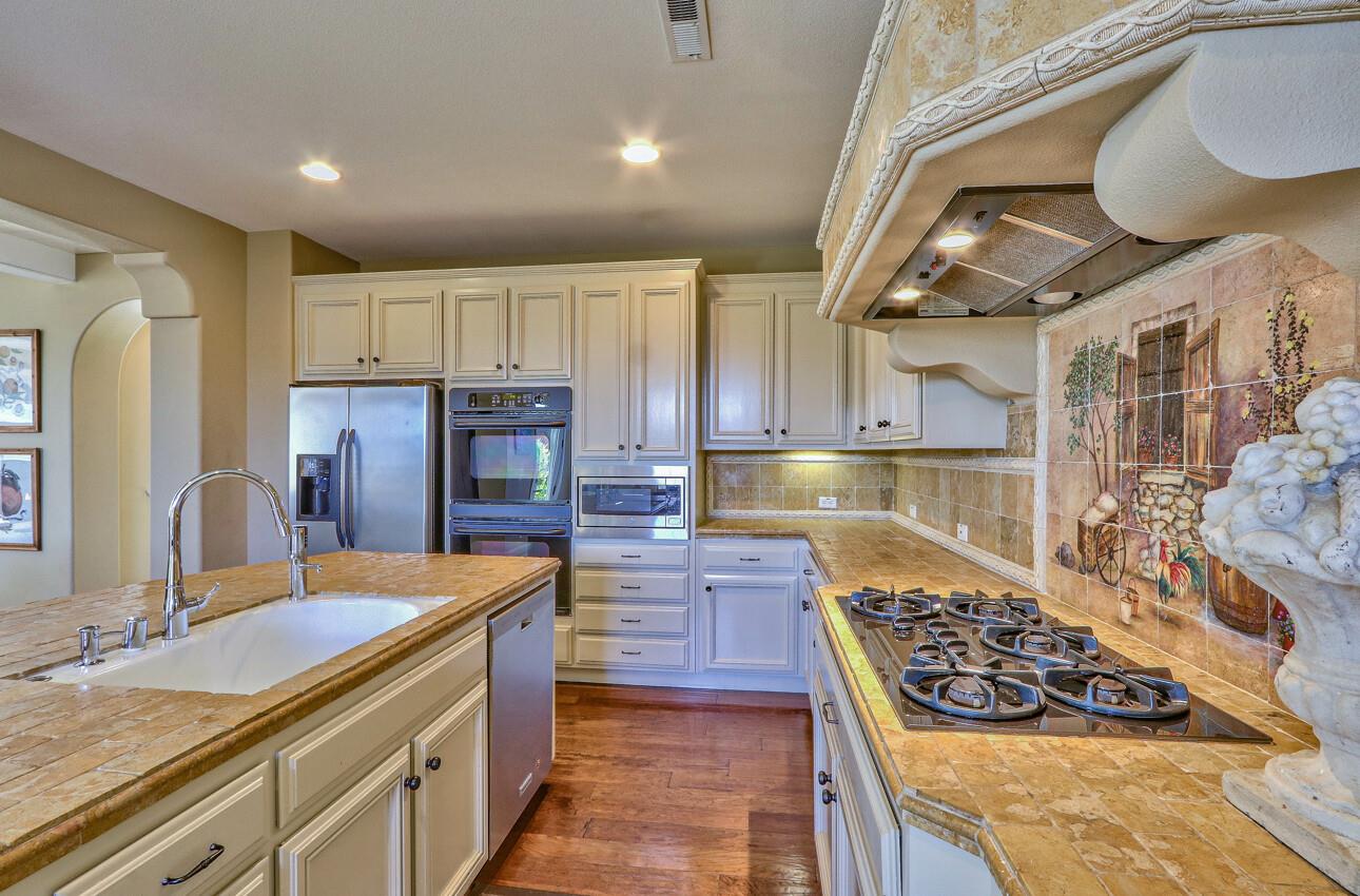 7260 Eagle Ridge Drive Gilroy, CA 95020 - Photo 10 of 36 a kitchen with stainless steel appliances granite countertop a stove and a sink