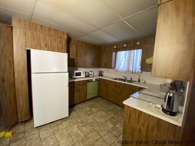 342 Awosting Road Pine Bush, NY 12566 - Photo 6 of 21 a kitchen with a refrigerator a sink and a stove