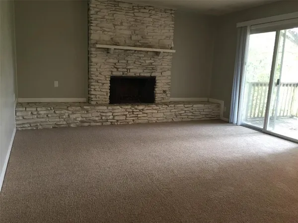 a view of empty room with fireplace