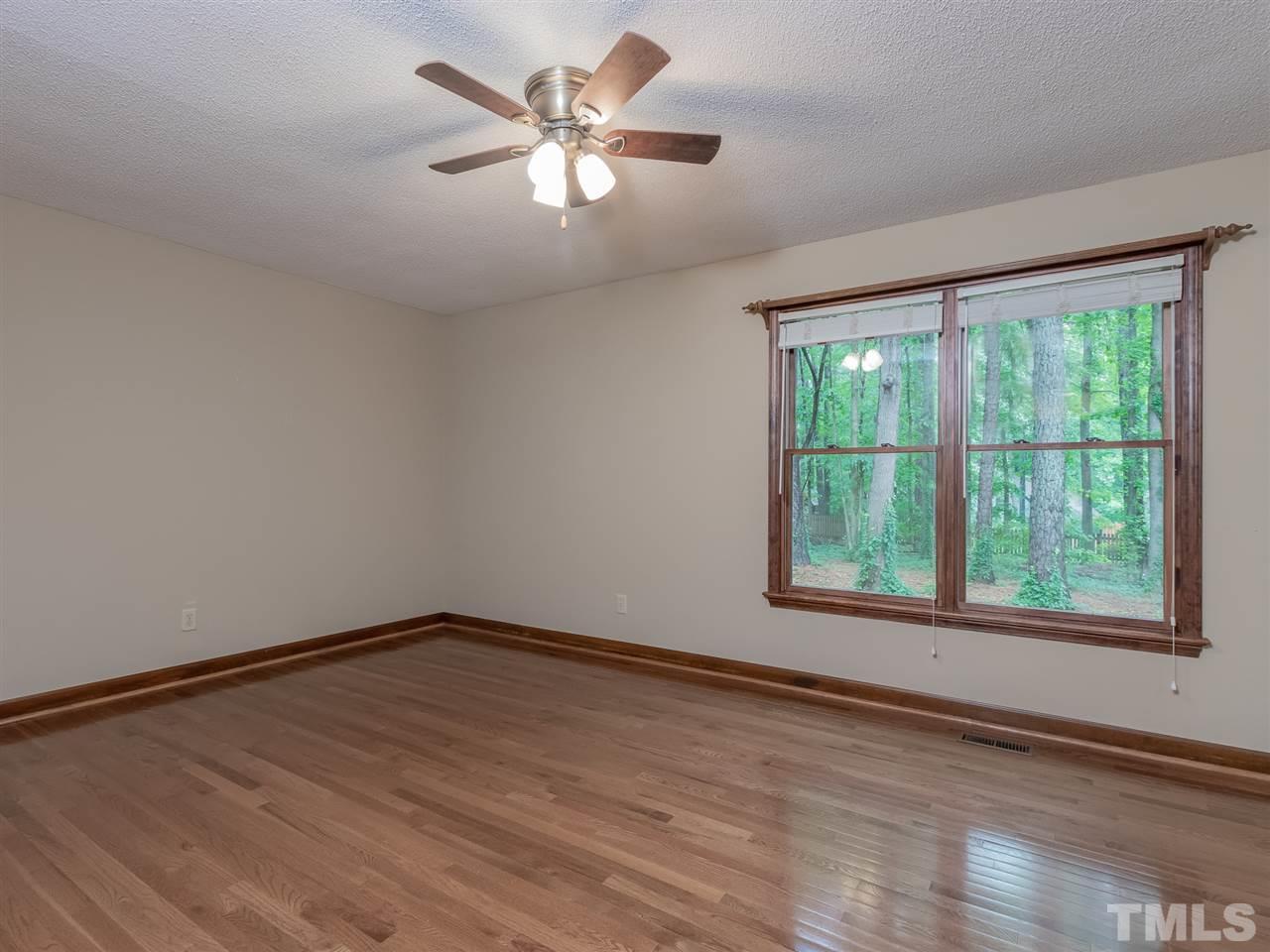 8701 Brandon Station Road Raleigh, NC 27613 - Photo 12 of 30 Your master retreat with hardwood floors overlooking the private backyard.
