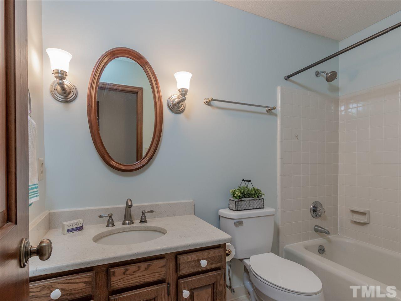 8701 Brandon Station Road Raleigh, NC 27613 - Photo 21 of 30 Quartz counter tops and convenient access to second and third bedrooms.