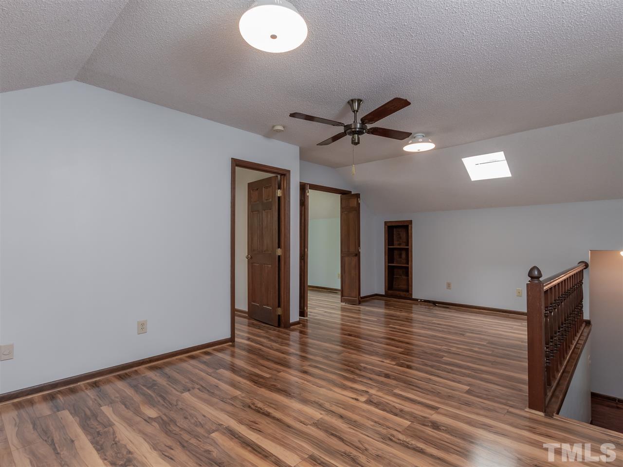 8701 Brandon Station Road Raleigh, NC 27613 - Photo 23 of 30 Bonus room is light and bright with newly installed durable laminate flooring.