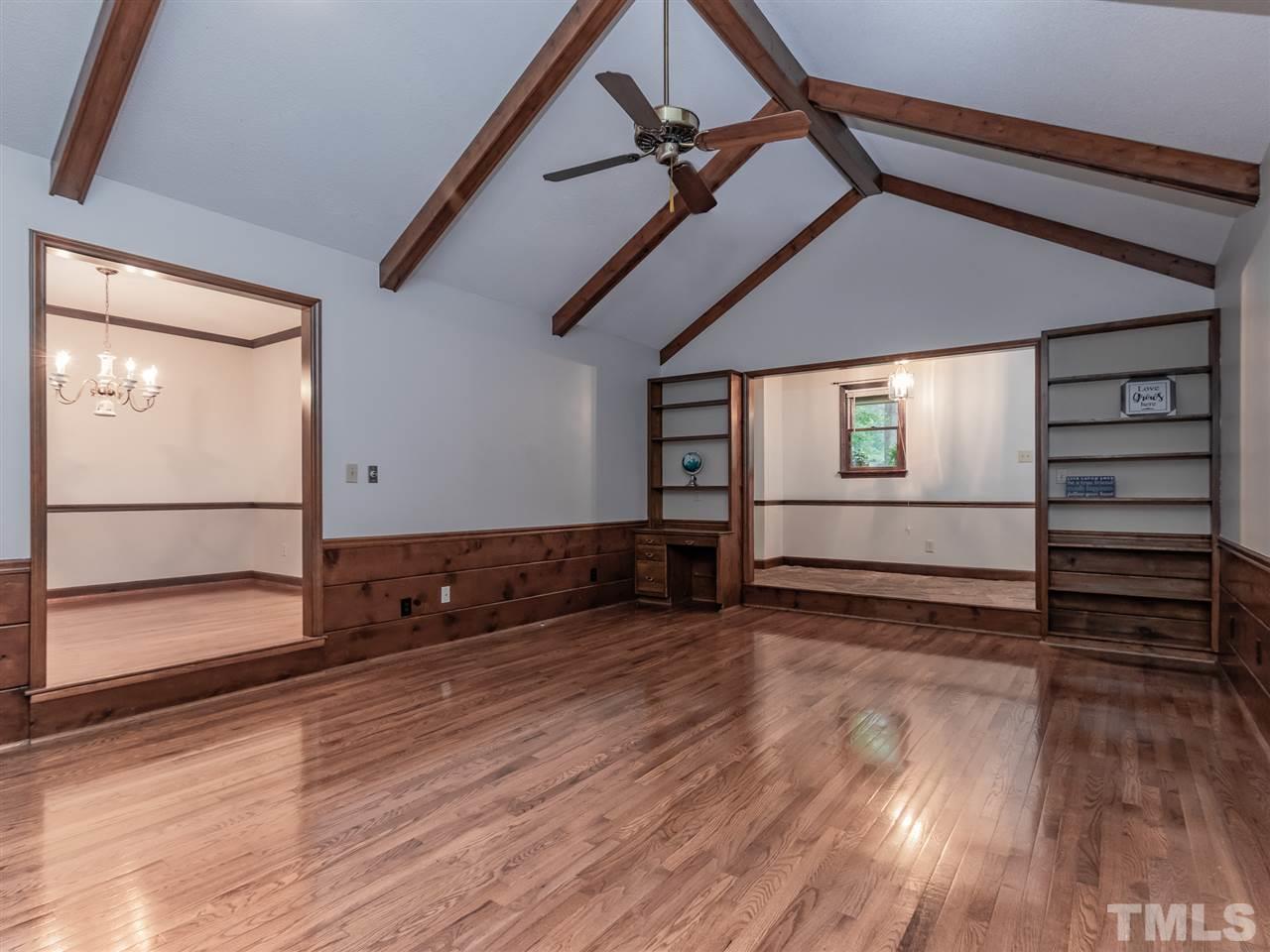 8701 Brandon Station Road Raleigh, NC 27613 - Photo 4 of 30 So much attention to detail with beautiful natural stone entry, gleaming hardwood floors, built-ins with desk area, and the vaulted ceiling with exposed beams are a standout design feature.