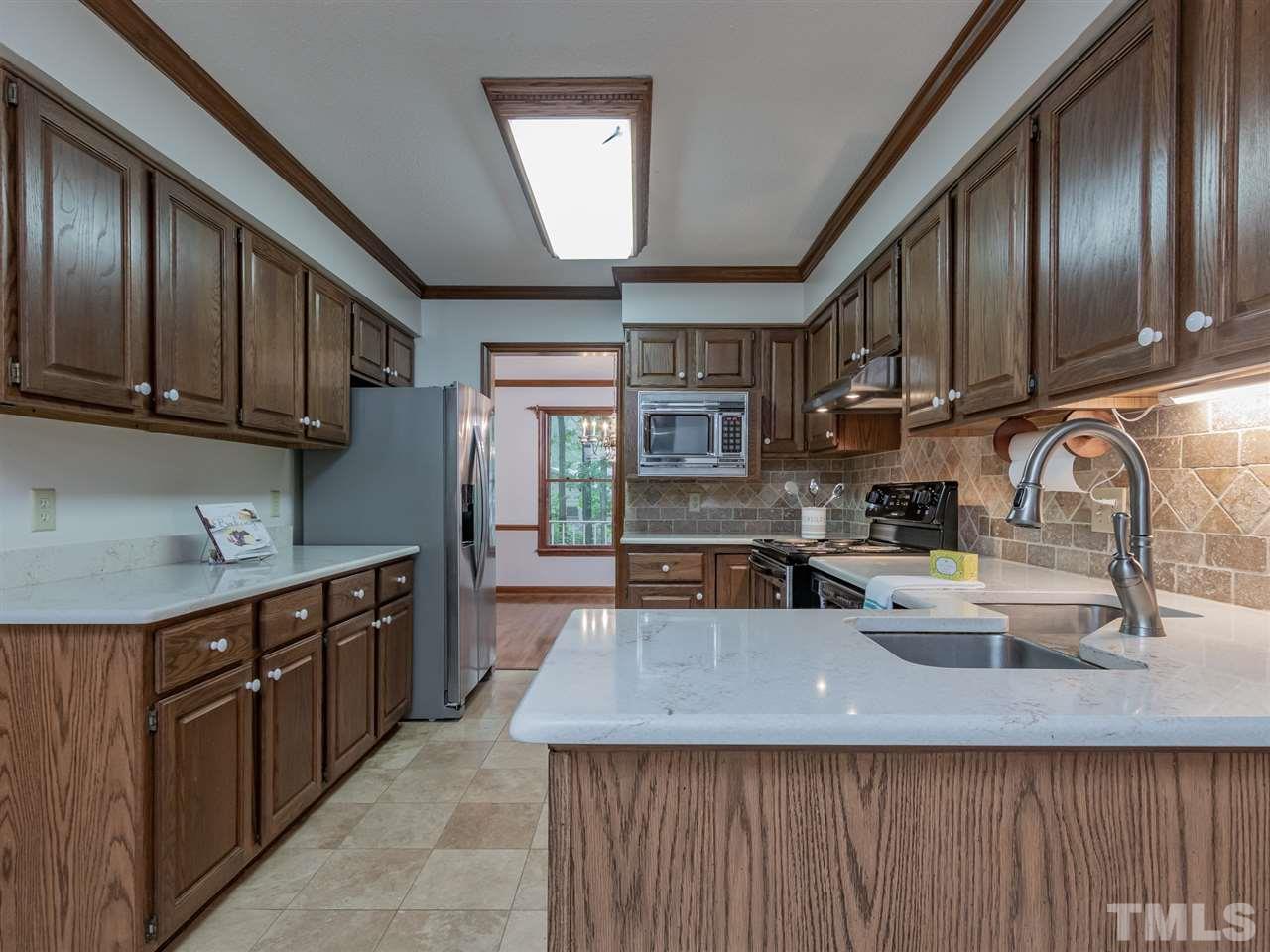 8701 Brandon Station Road Raleigh, NC 27613 - Photo 10 of 30 Cabinets have convenient roll out shelving.