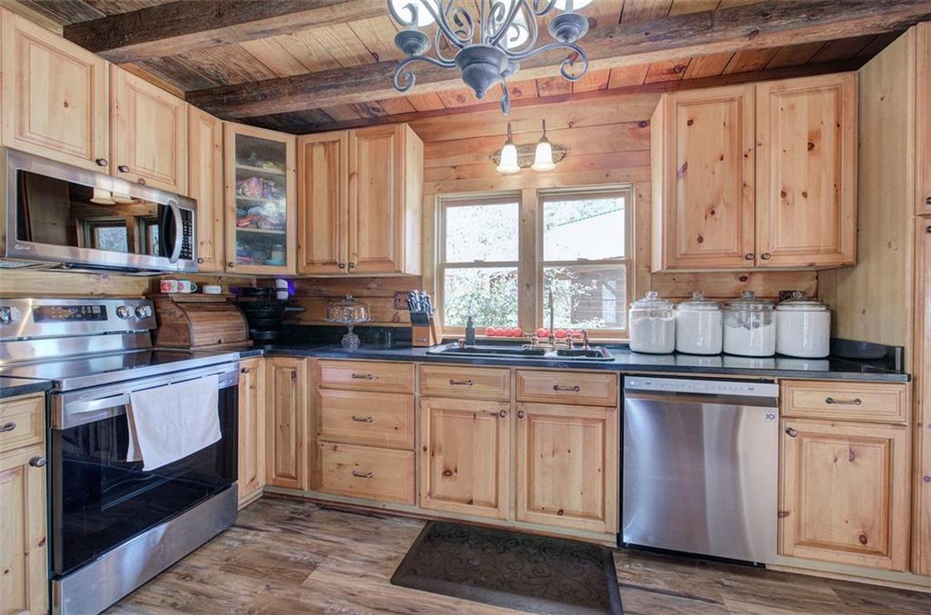 1252 Paris Mountain Road Rockmart, GA 30153 - Photo 15 of 93 a kitchen with granite countertop white cabinets and window