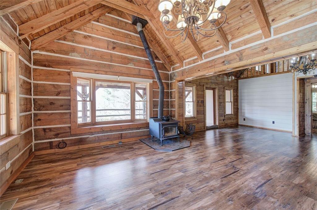 1252 Paris Mountain Road Rockmart, GA 30153 - Photo 26 of 93 a view of an empty room with wooden floor and a window