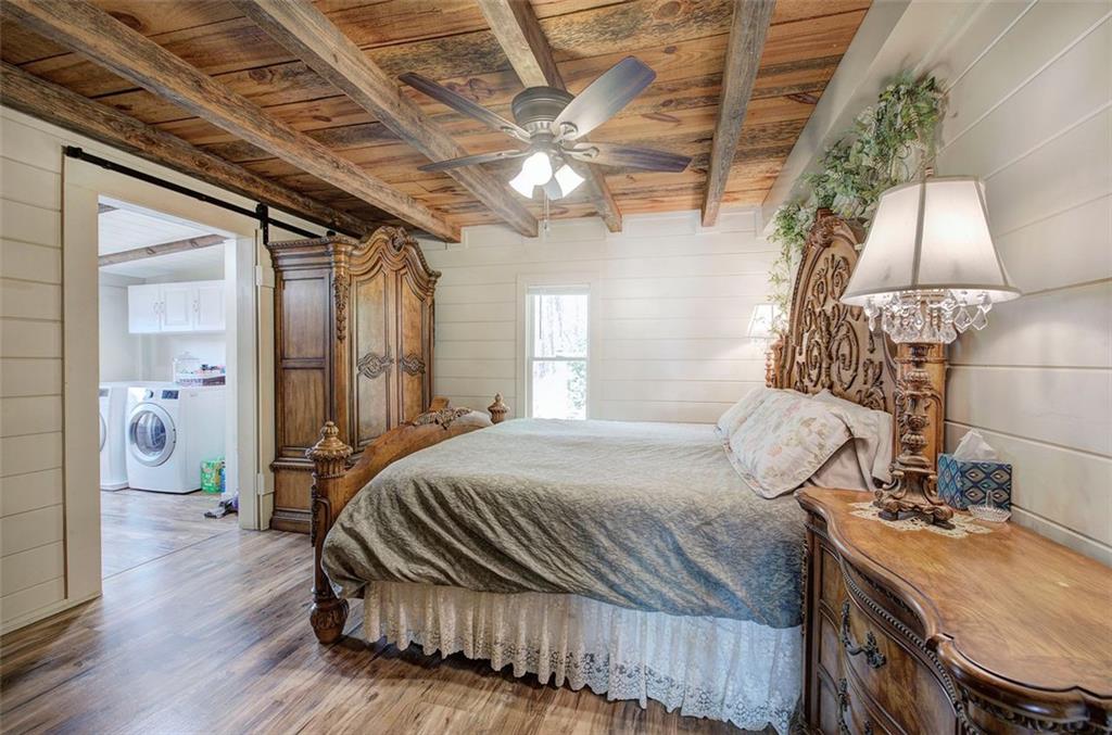 1252 Paris Mountain Road Rockmart, GA 30153 - Photo 30 of 93 a bedroom with a bed and a chandelier