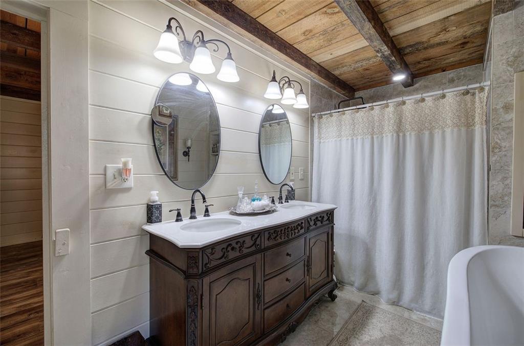 1252 Paris Mountain Road Rockmart, GA 30153 - Photo 33 of 93 a bathroom with a double vanity sink and a mirror