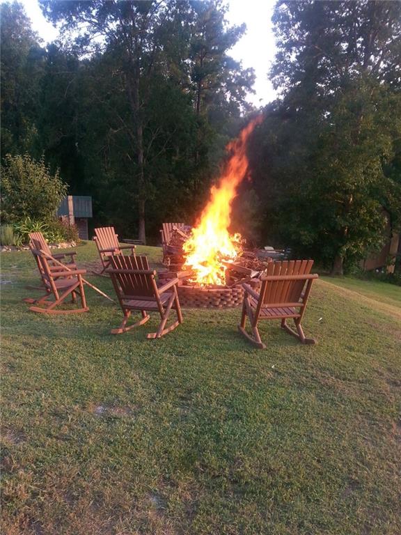 1252 Paris Mountain Road Rockmart, GA 30153 - Photo 84 of 93 a backyard of a house with table and chairs