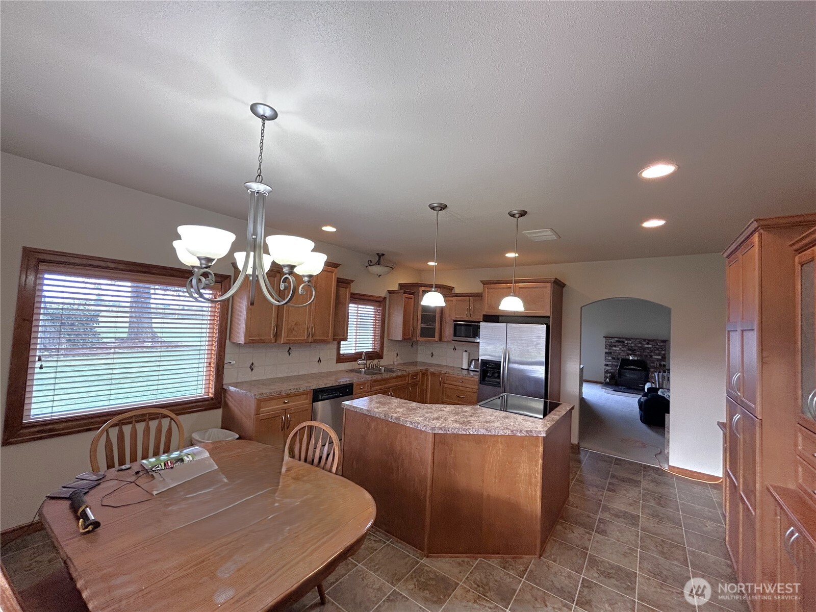 1925 Hampton Road Everson, WA 98247 - Photo 15 of 40 a kitchen with a dining table wooden floor and a chandelier