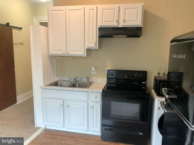 a kitchen with stainless steel appliances granite countertop a stove and a microwave