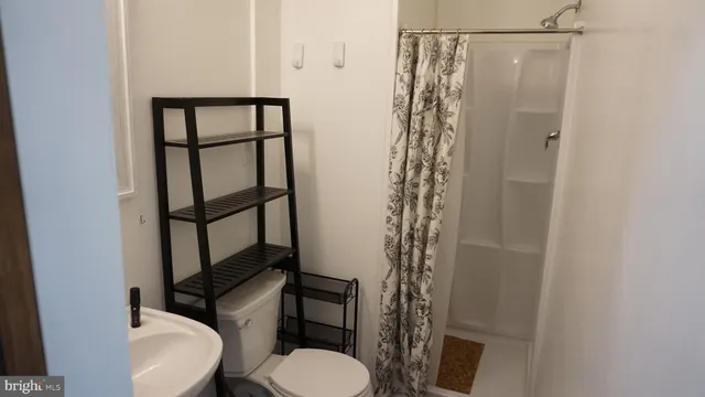 a bathroom with a toilet and a shower