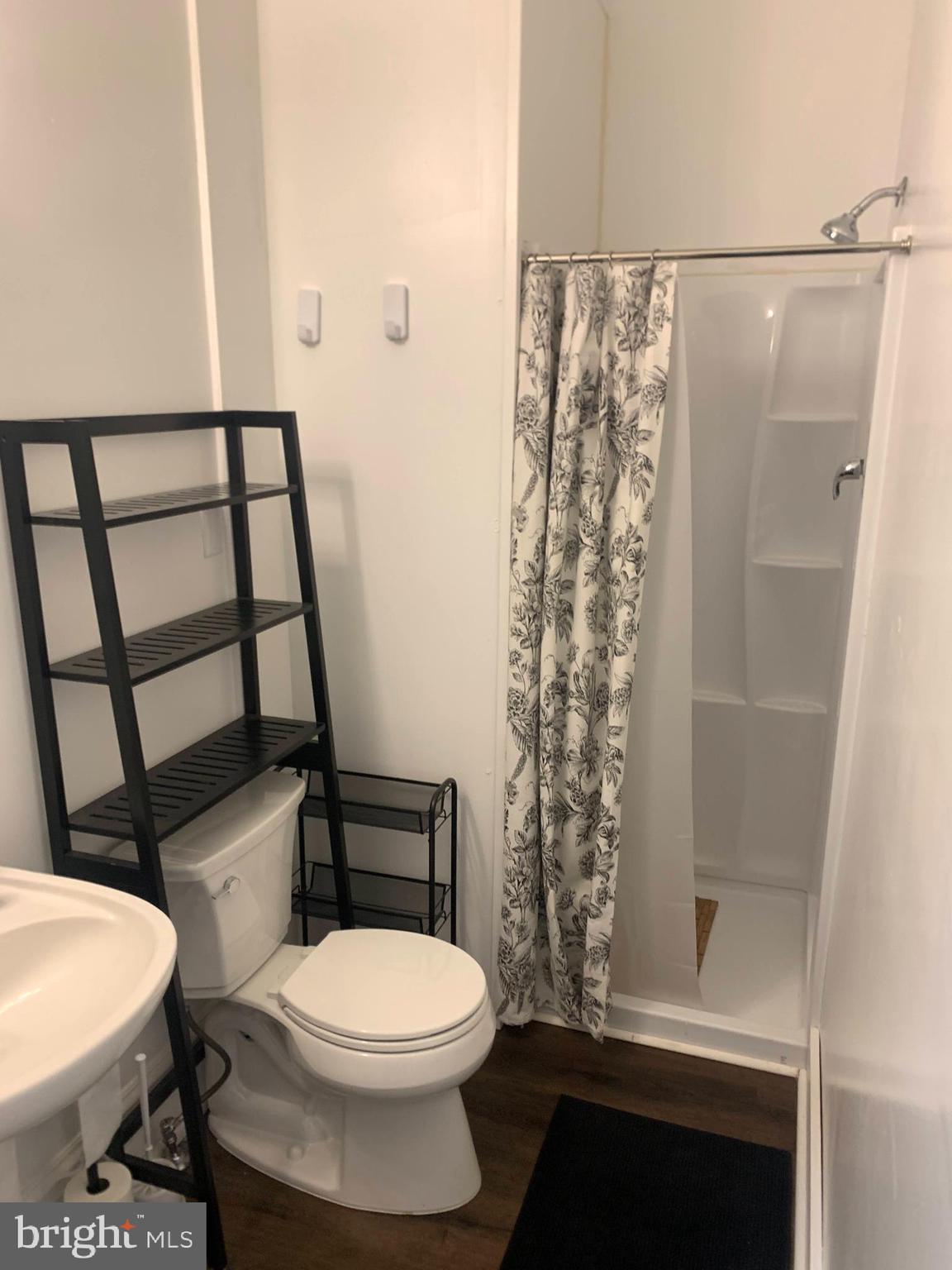 200 East Walnut Street, Unit 3 Hanover, PA 17331 - Photo 6 of 12 a white toilet sitting next to a shower curtain