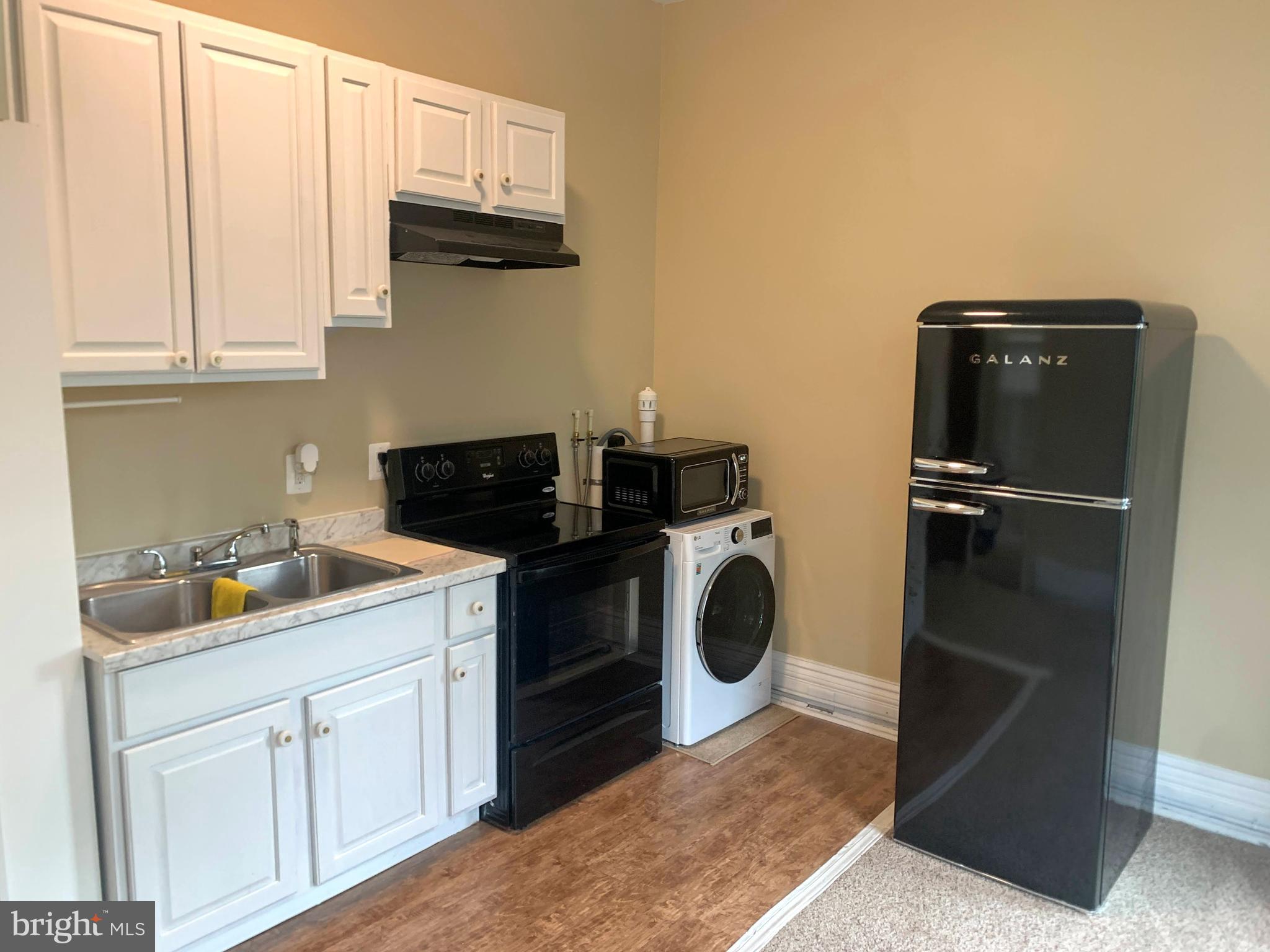 200 East Walnut Street, Unit 3 Hanover, PA 17331 - Photo 8 of 12 a kitchen with a refrigerator and cabinets