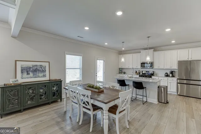a kitchen that has a table and chairs in it