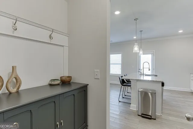 a kitchen with granite countertop a sink a stove and cabinets