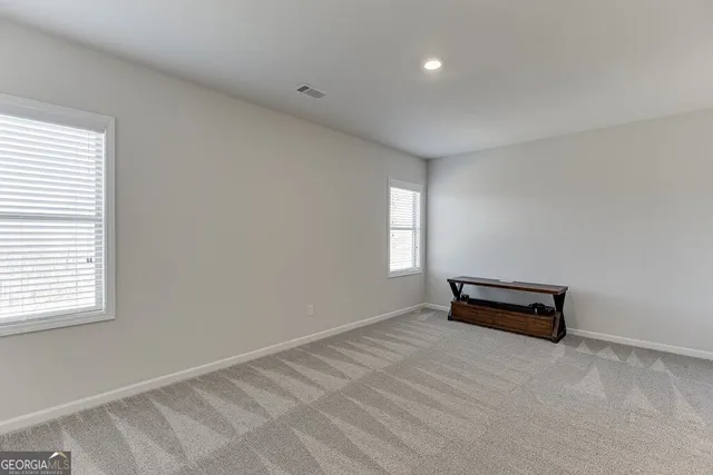a view of a room with gym equipment and windows
