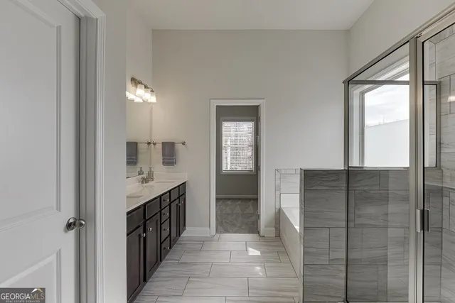 a bathroom with a bathtub and shower