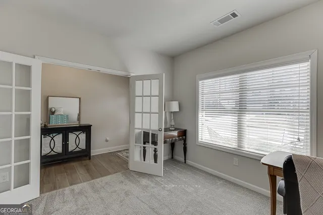 a livingroom with workspace and a window
