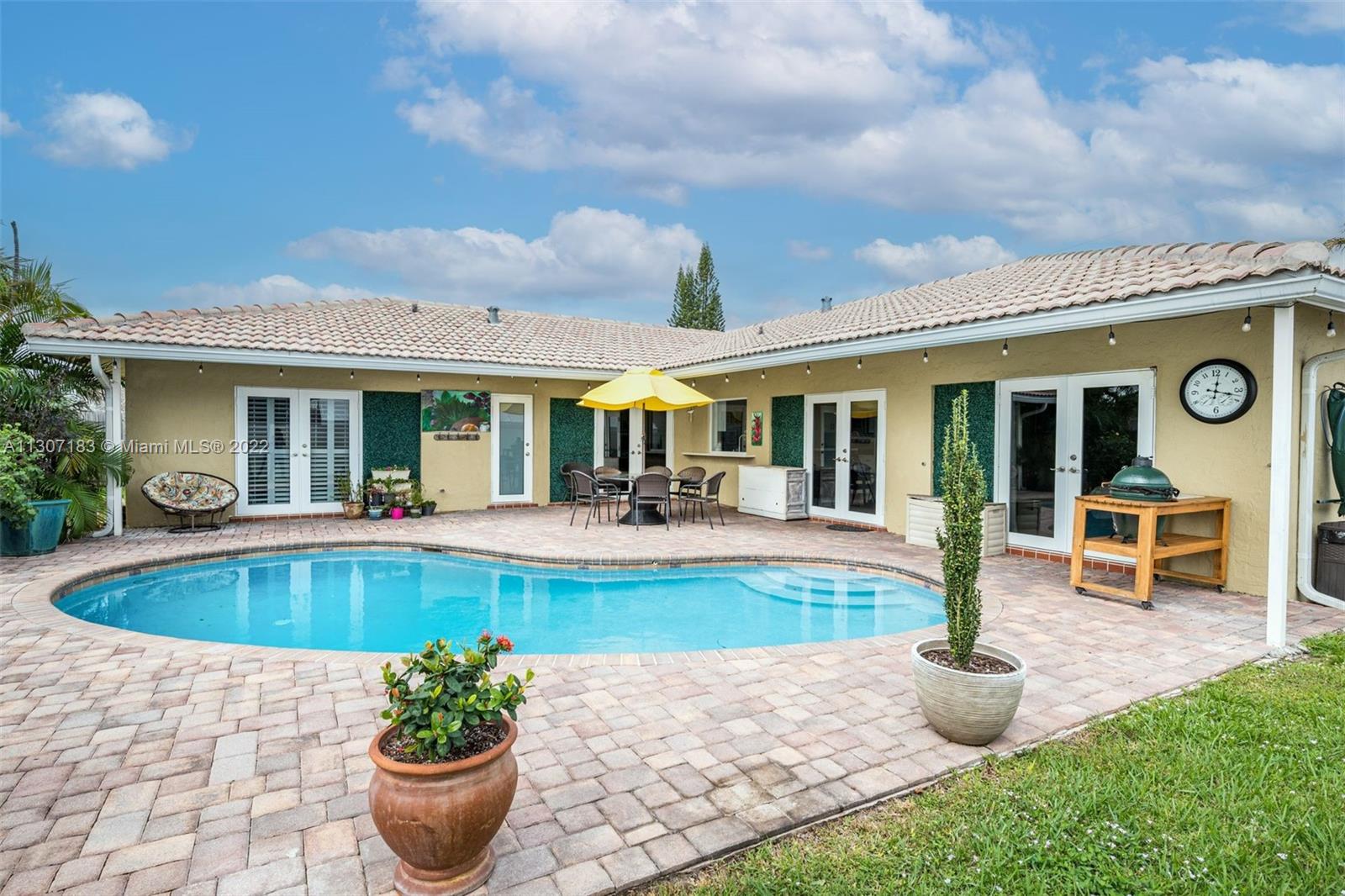 a view of a house with swimming pool and porch with furniture