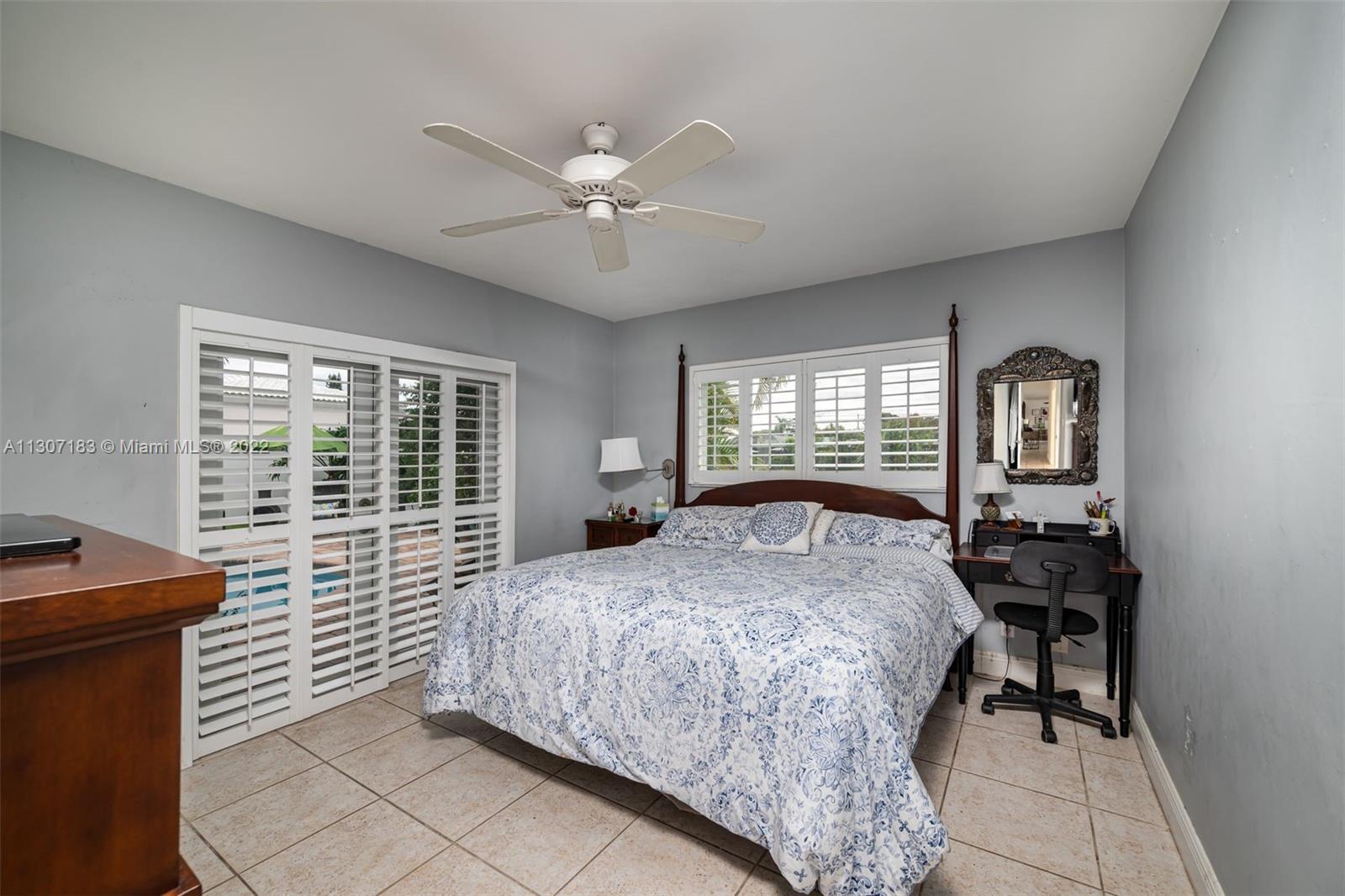 1592 Northwest 8th Street Boca Raton, FL 33486 - Photo 17 of 35 a bedroom with a bed and a table