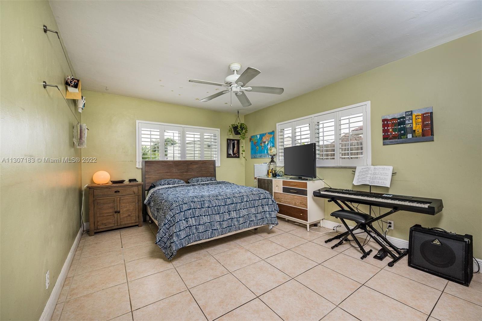 1592 Northwest 8th Street Boca Raton, FL 33486 - Photo 18 of 35 a bedroom with furniture and a bed