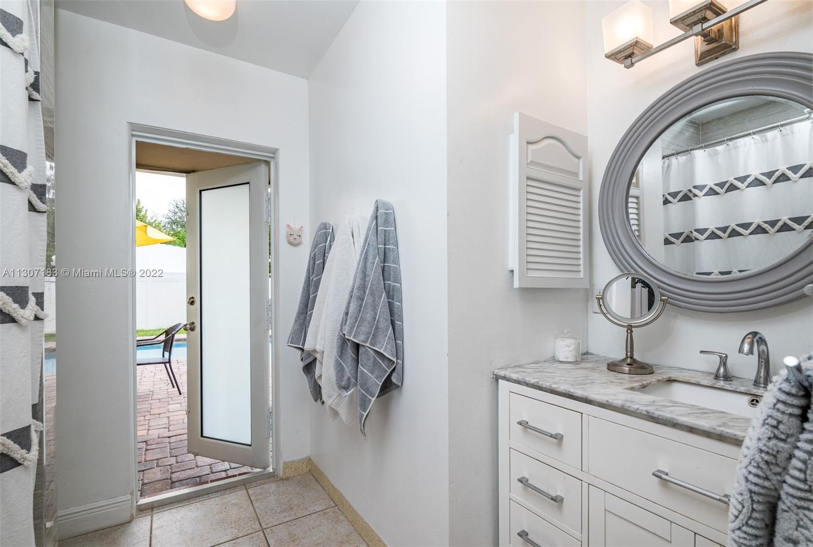 1592 Northwest 8th Street Boca Raton, FL 33486 - Photo 19 of 35 a bathroom with a granite countertop sink and a mirror
