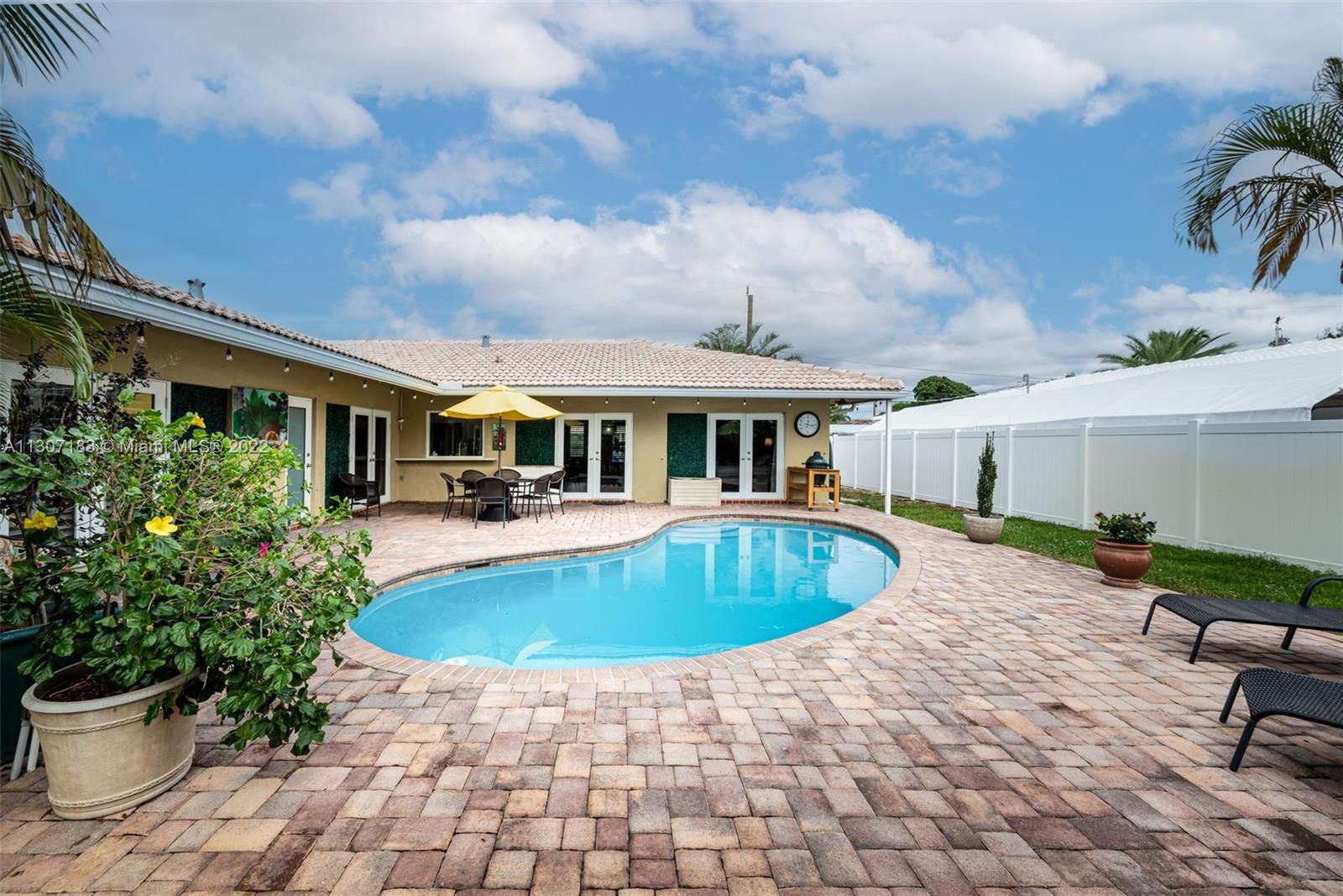1592 Northwest 8th Street Boca Raton, FL 33486 - Photo 22 of 35 a front view of a house with swimming pool
