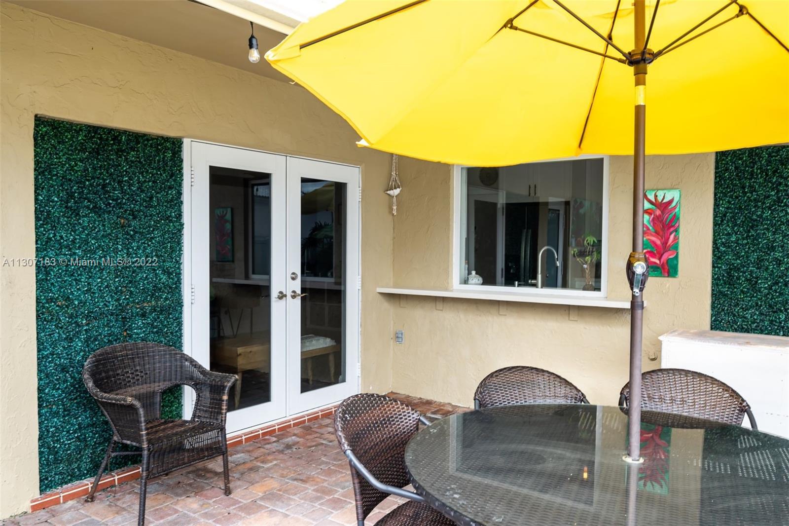 1592 Northwest 8th Street Boca Raton, FL 33486 - Photo 25 of 35 a front view of a house with outdoor seating