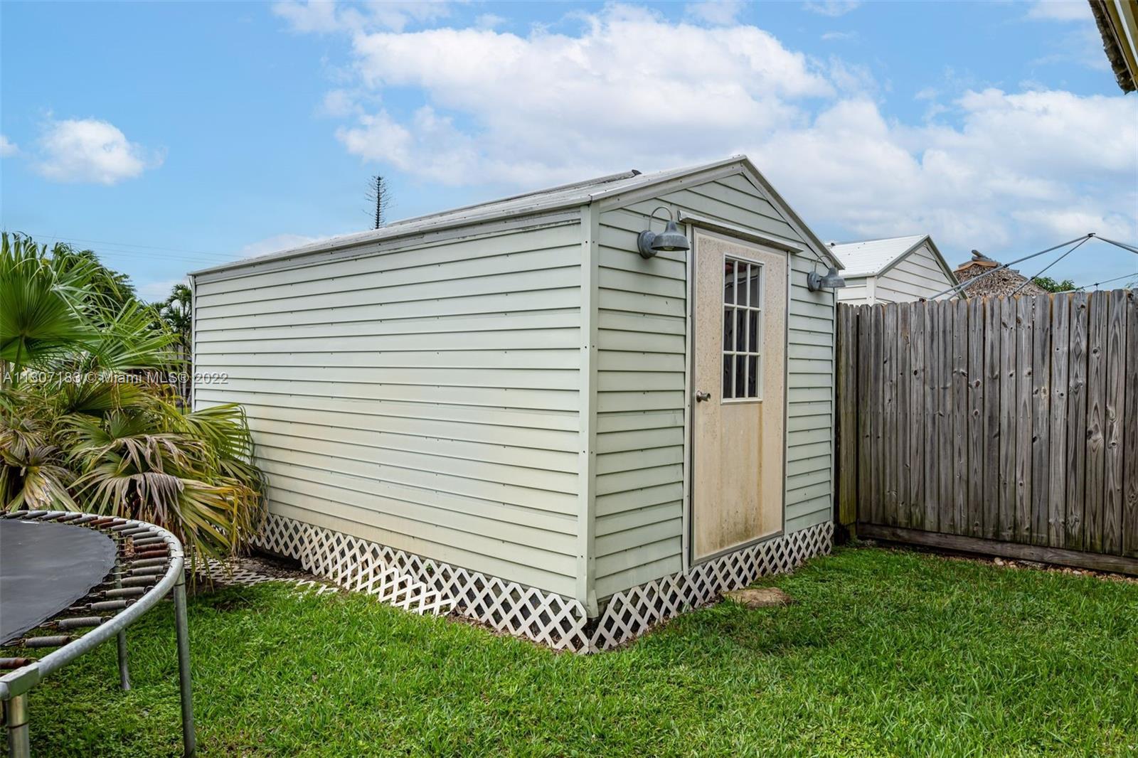 1592 Northwest 8th Street Boca Raton, FL 33486 - Photo 26 of 35 a view of a house with a yard and plants