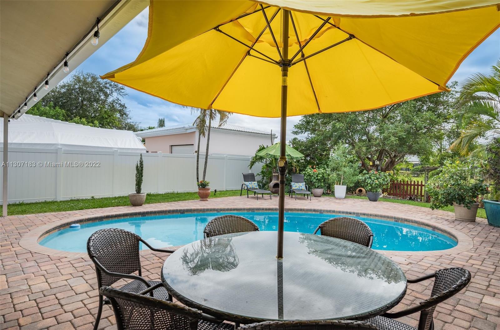 1592 Northwest 8th Street Boca Raton, FL 33486 - Photo 27 of 35 a table and chairs in the patio