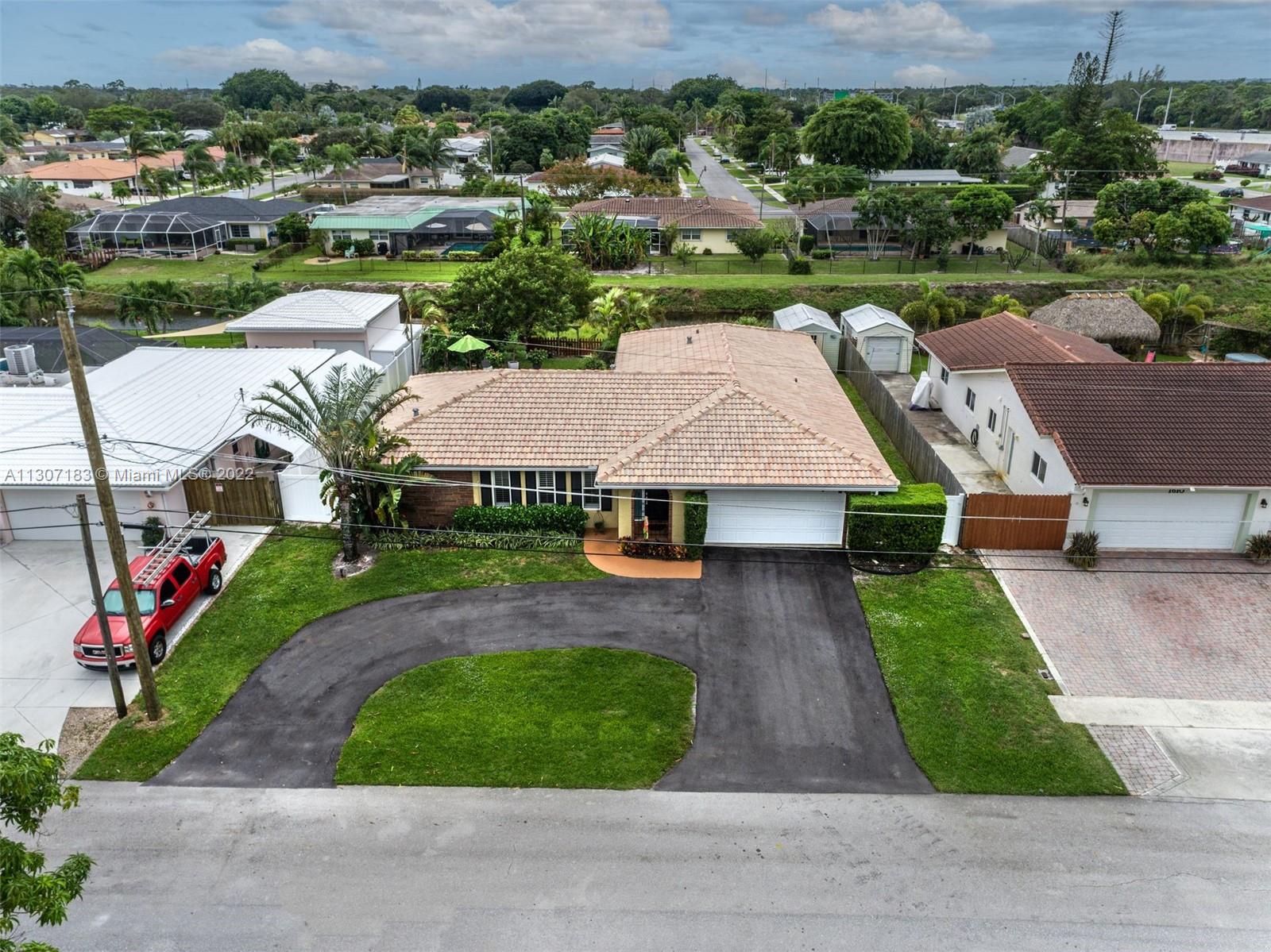 1592 Northwest 8th Street Boca Raton, FL 33486 - Photo 34 of 35 an aerial view of a house with garden space and street view